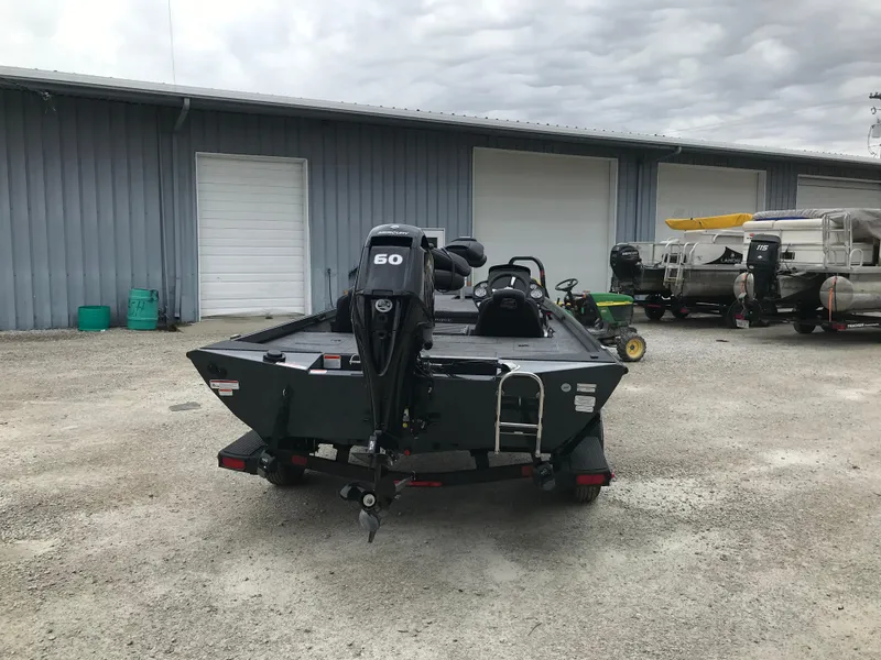 Slide: The Image of 2025 Ranger RT178 boat with Mercury motor, parked outdoors near silos. - 3