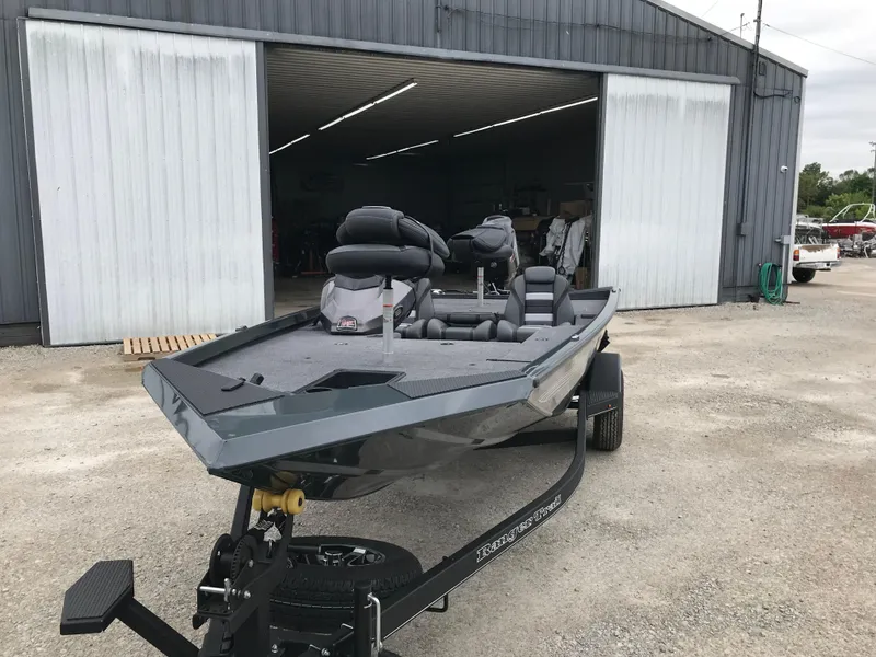 Slide: The Image of 2025 Ranger RT178 boat with 60HP motor parked outside a warehouse. - 4