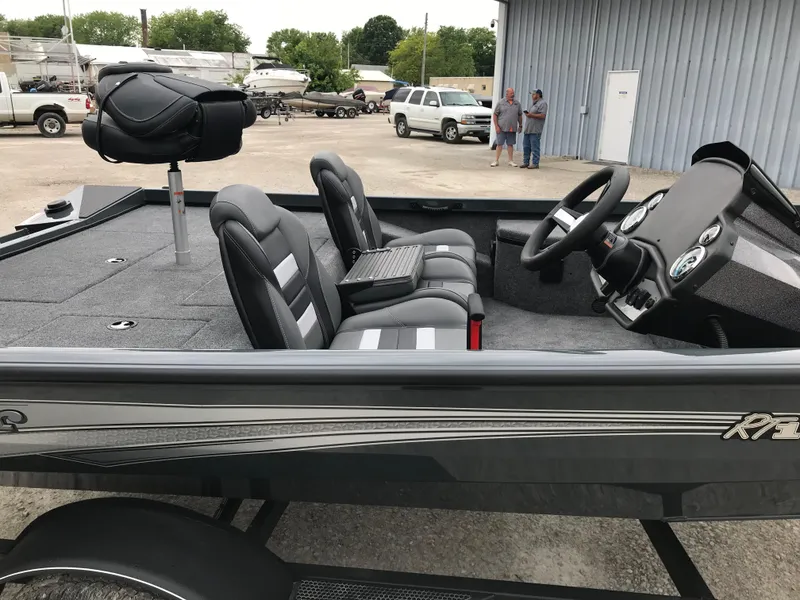 Slide: The Image of 2025 Ranger RT178 fishing boat with seating, parked outside a garage. - 6