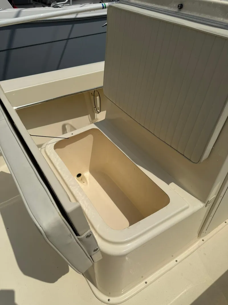 Slide: The Image of 2020 Jones Brothers 23 Cape Fisherman Lite Tackle boat with open storage compartment. - 11