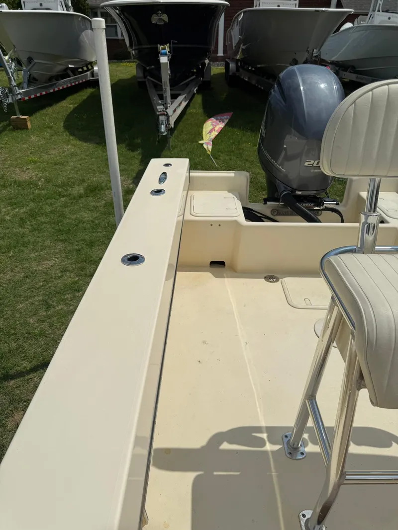 Slide: The Image of 2020 Jones Brothers 23 Cape Fisherman Lite Tackle boat, featuring seating and motor, displayed outdoors. - 14