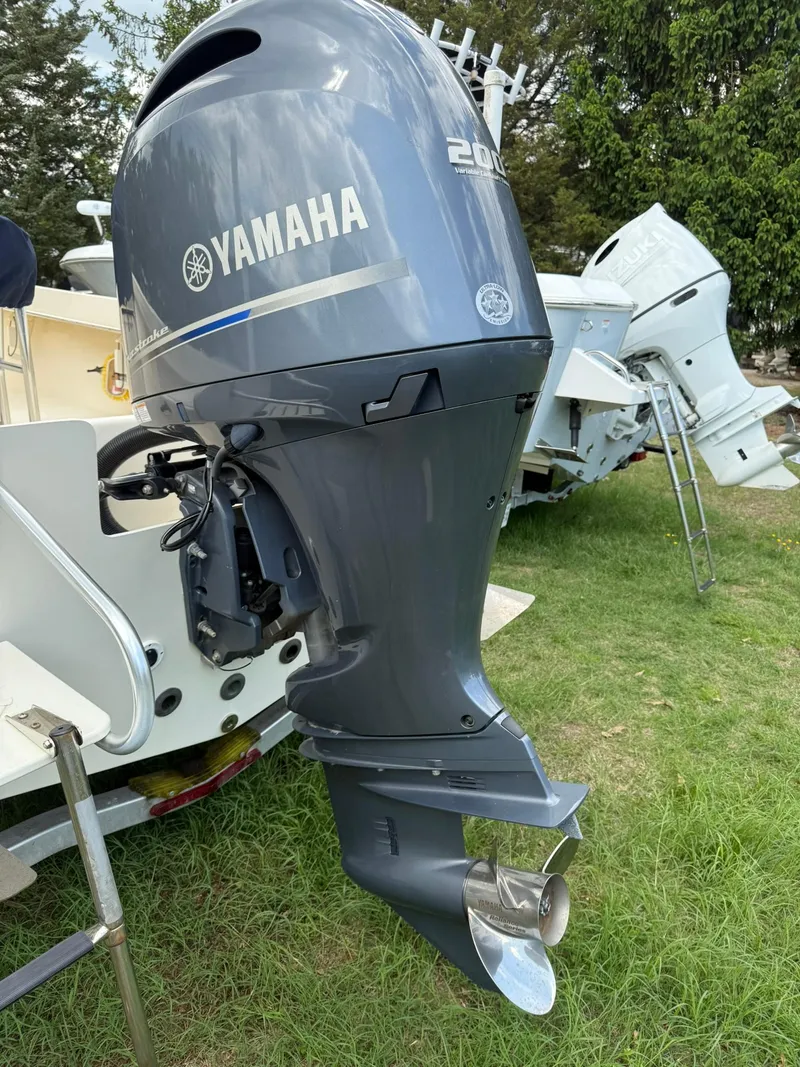 Slide: The Image of 2020 Jones Brothers 23 Cape Fisherman with Yamaha outboard motor, parked on grass. - 19