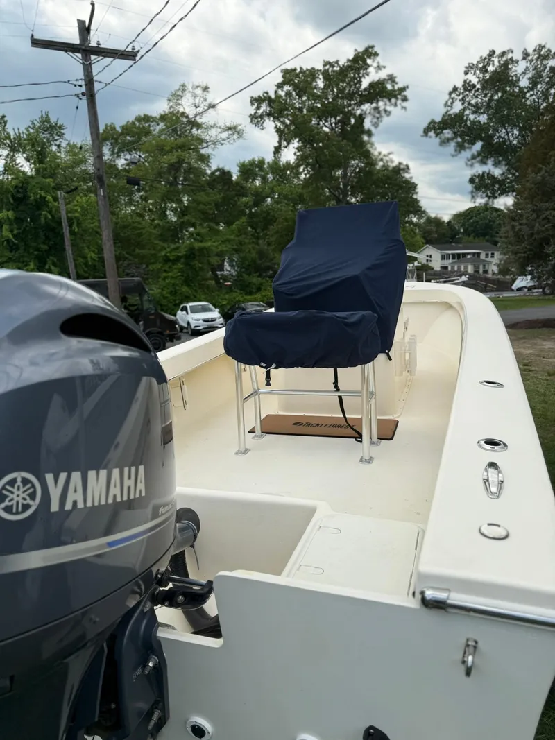 Slide: The Image of 2020 Jones Brothers 23 Cape Fisherman Lite Tackle boat with Yamaha engine, docked outdoors. - 25