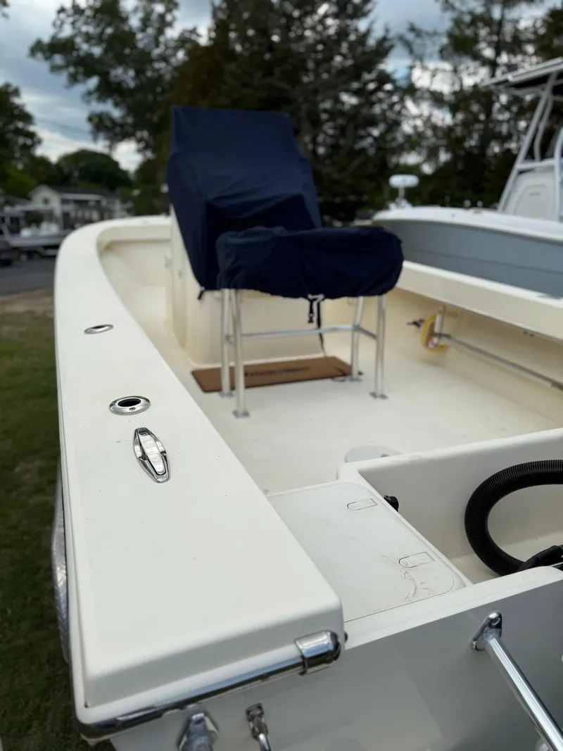Slide: The Image of 2020 Jones Brothers 23 Cape Fisherman Lite Tackle boat, featuring a covered seat and spacious deck. - 26