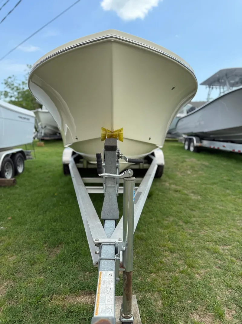 Slide: The Image of 2020 Jones Brothers 23 Cape Fisherman Lite Tackle boat on trailer, parked on grass. - 27