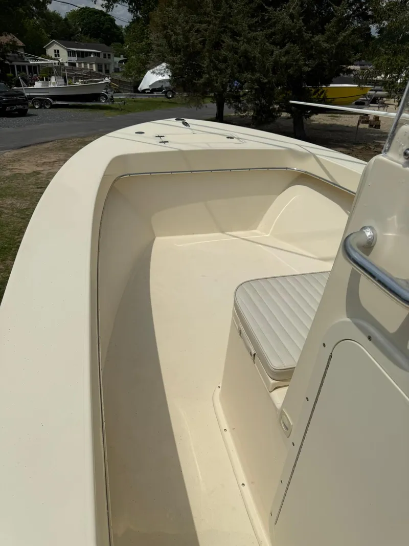 Slide: The Image of 2020 Jones Brothers 23 Cape Fisherman Lite Tackle boat, beige interior, docked outdoors. - 5