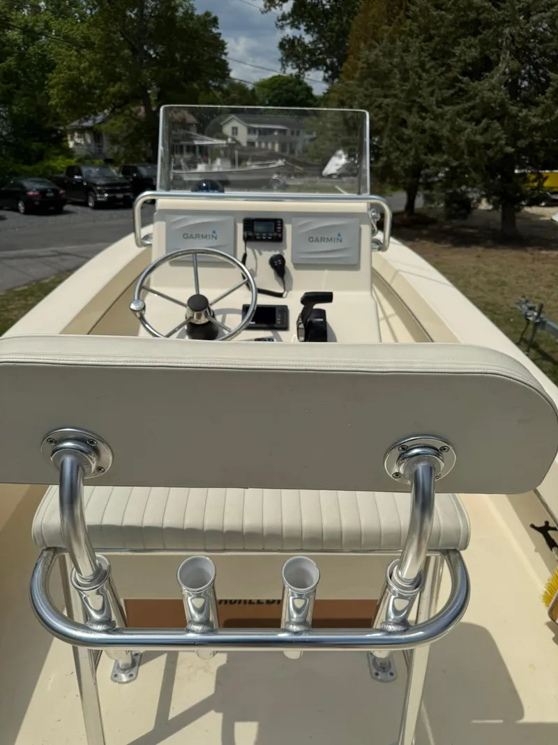 Slide: The Image of 2020 Jones Brothers 23 Cape Fisherman Lite Tackle boat interior with steering console and rod holders. - 7