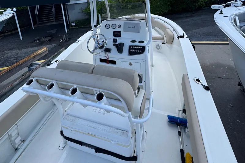 Slide: The Image of 2018 NauticStar 2102 Legacy boat interior with steering console and seating. - 4