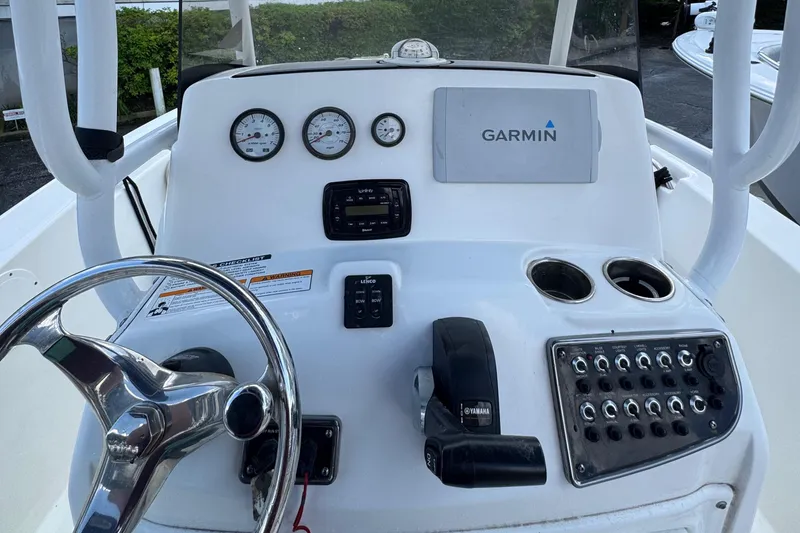 Slide: The Image of 2018 NauticStar 2102 Legacy boat dashboard with Garmin navigation system and controls. - 8