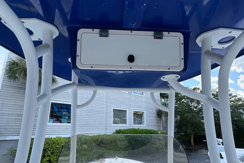 Slide: The Image of 2018 NauticStar 2102 Legacy boat with blue T-top and white frame. - 9