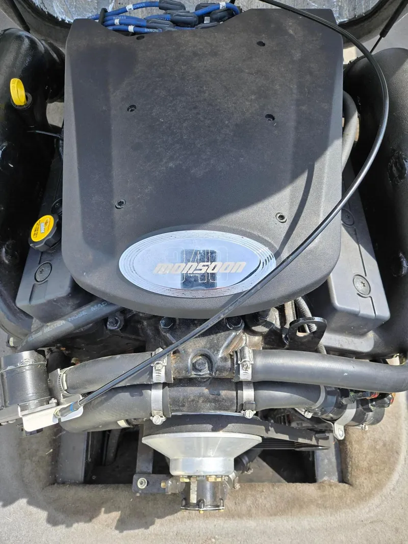 Slide: The Image of 2005 Malibu Response LXi Monsoon engine, top view, showcasing components and branding. - 18