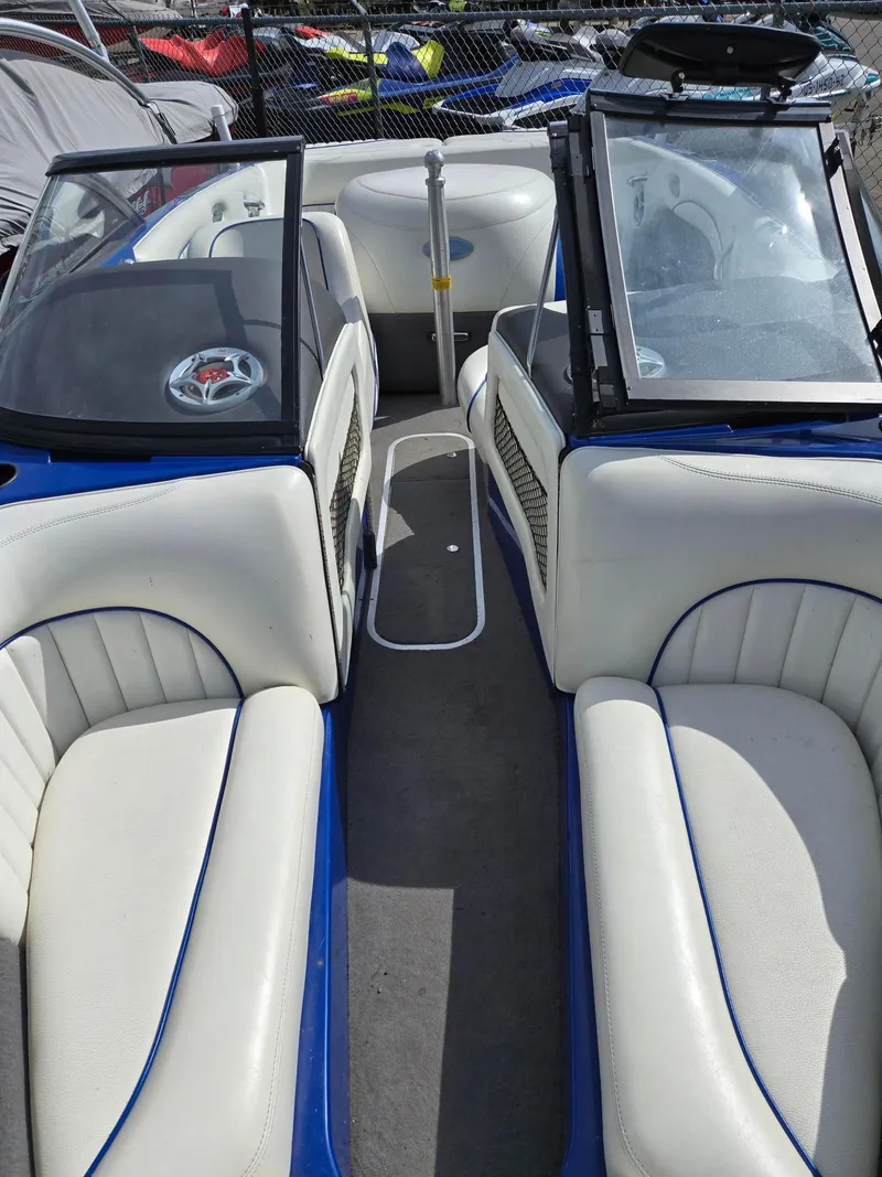 Slide: The Image of 2005 Malibu Response LXi boat interior with white seating and blue accents. - 7