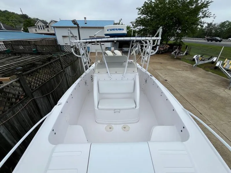 Slide: The Image of 2000 Donzi 35 ZF Daytona boat docked, showcasing spacious deck and seating. - 14