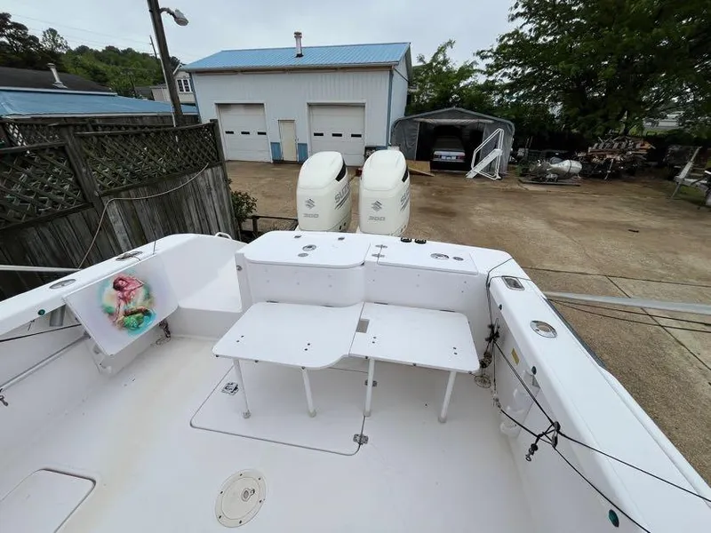Slide: The Image of 2000 Donzi 35 ZF Daytona boat with dual engines, docked near a garage. - 6