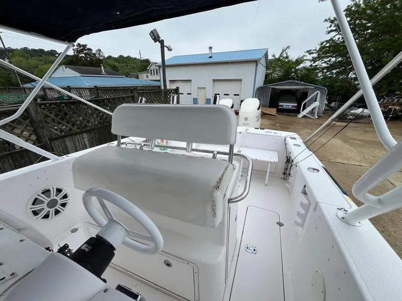 Slide: The Image of 2000 Donzi 35 ZF Daytona boat interior with steering wheel and seating, docked near buildings. - 7