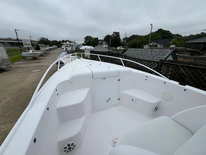 Slide: The Image of 2000 Donzi 35 ZF Daytona boat deck with seating and storage, parked outdoors. - 8