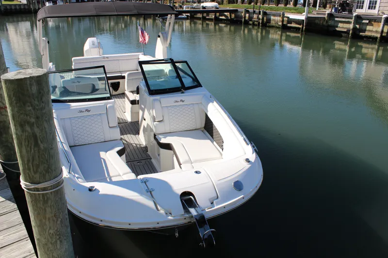 Slide: The Image of 2020 Sea Ray SDX 270 OB boat docked in calm marina waters. - 21