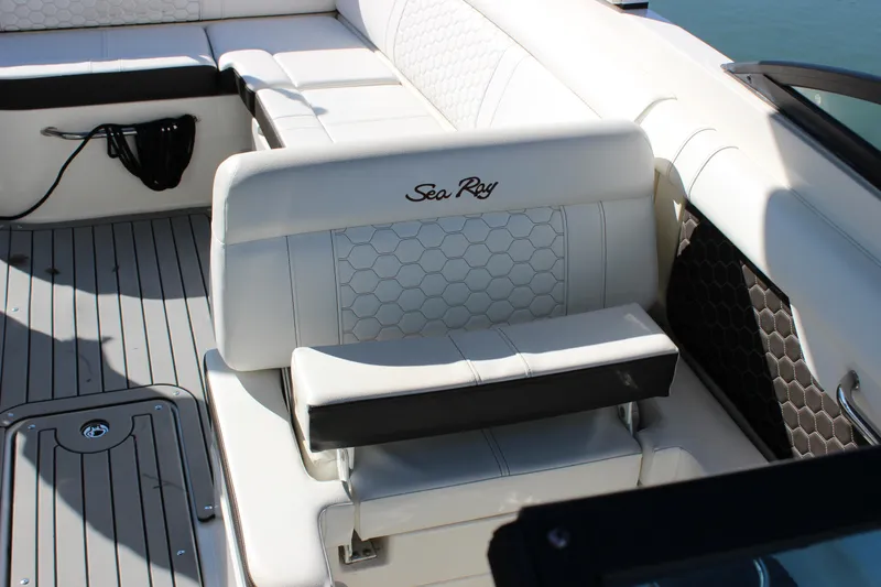 Slide: The Image of 2020 Sea Ray SDX 270 OB boat interior with white seating and hexagonal pattern. - 27