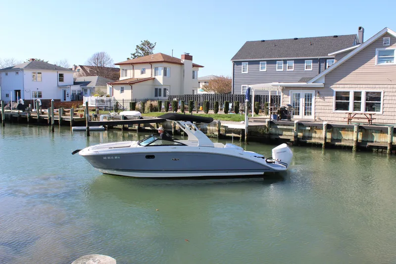 Slide: The Image of 2020 Sea Ray SDX 270 OB boat docked in a residential canal. - 5