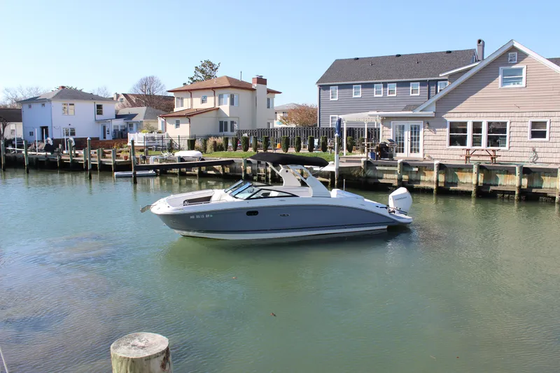 Slide: The Image of 2020 Sea Ray SDX 270 OB boat docked in a residential waterfront area. - 6