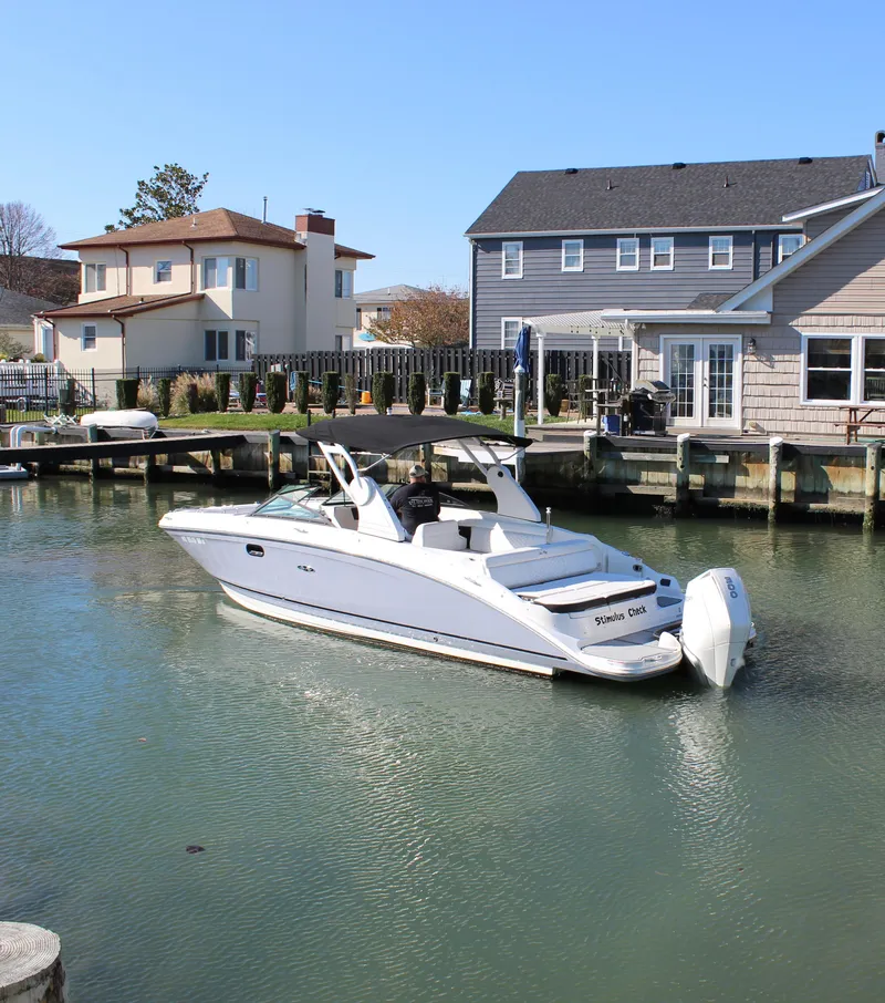 Slide: The Image of 2020 Sea Ray SDX 270 OB boat docked in a residential canal. - 8
