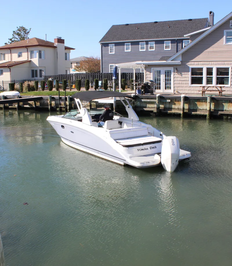 Slide: The Image of 2020 Sea Ray SDX 270 OB boat docked in a residential canal. - 9