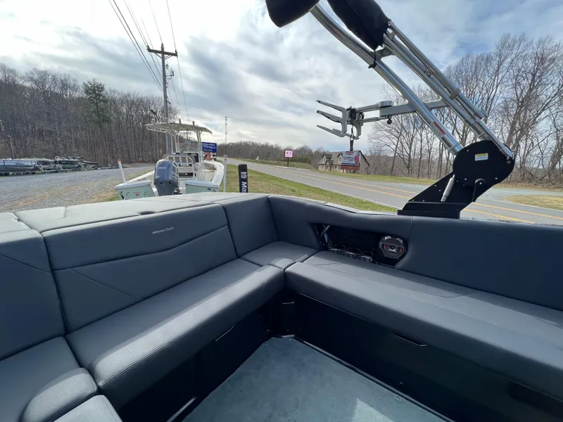 Slide: The Image of 2020 MasterCraft NXT22 boat interior with gray seating and wakeboard tower. - 11
