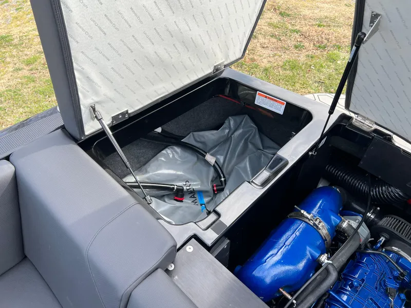 Slide: The Image of 2020 MasterCraft NXT22 boat storage compartment with engine and equipment. - 18