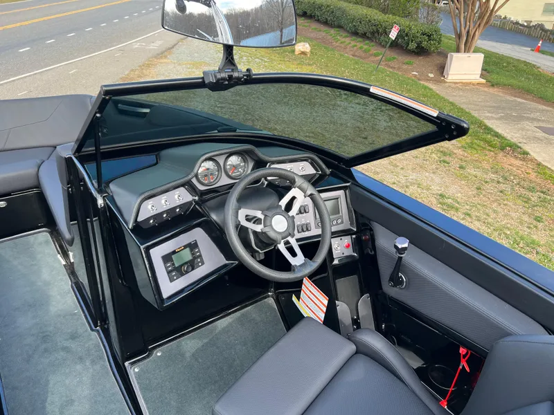 Slide: The Image of 2020 MasterCraft NXT22 boat cockpit with steering wheel and dashboard controls. - 7