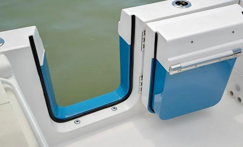 Slide: The Image of 2018 Edgewater 262 CX boat with open transom door, blue interior, and water view. - 11