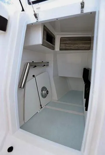 Slide: The Image of 2018 Edgewater 262 CX boat interior cabin with storage compartments and sleek design. - 12
