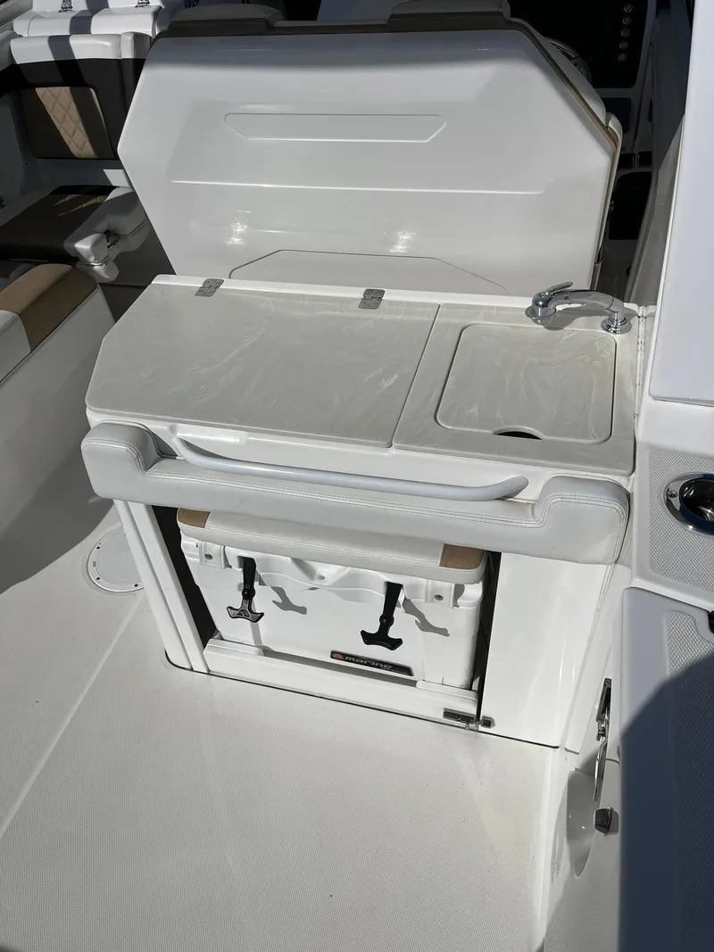 Slide: The Image of 2018 Edgewater 262 CX boat interior with storage and sink area. - 15