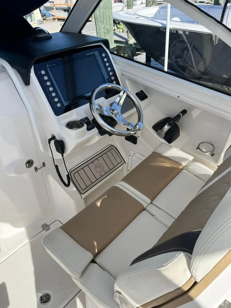 Slide: The Image of 2018 Edgewater 262 CX boat cockpit with modern steering and control panel. - 20