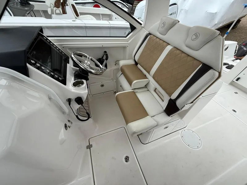 Slide: The Image of 2018 Edgewater 262 CX boat interior with dual seats and steering console. - 9