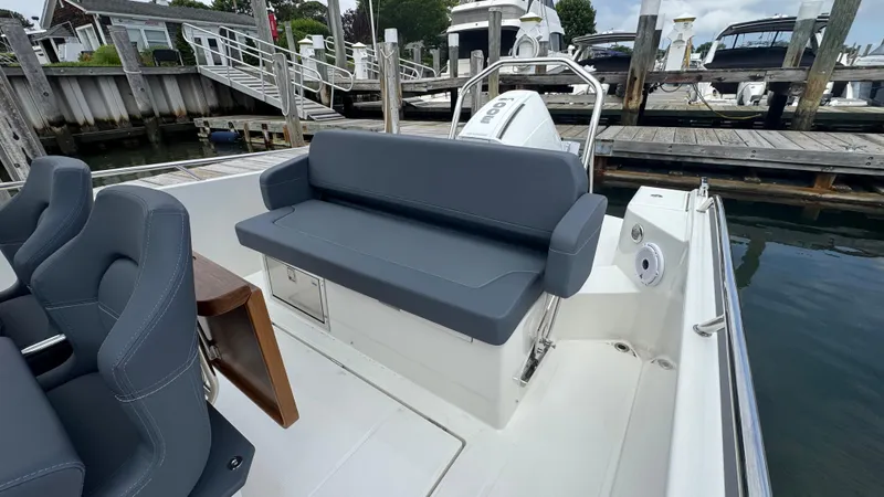 Slide: The Image of 2024 Nimbus T8 boat with gray seating at a marina dock. - 11