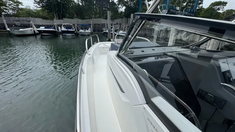 Slide: The Image of 2024 Nimbus T8 boat docked in a marina, showcasing sleek design and modern features. - 19