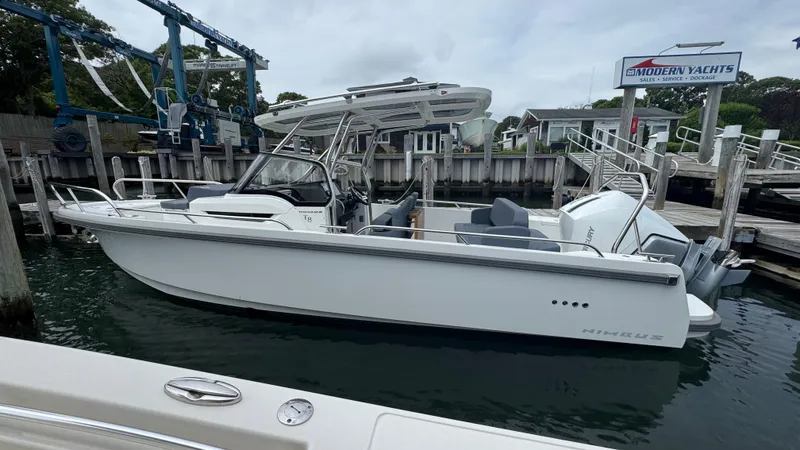 Slide: The Image of 2024 Nimbus T8 boat docked at a marina, showcasing sleek design and modern features. - 2