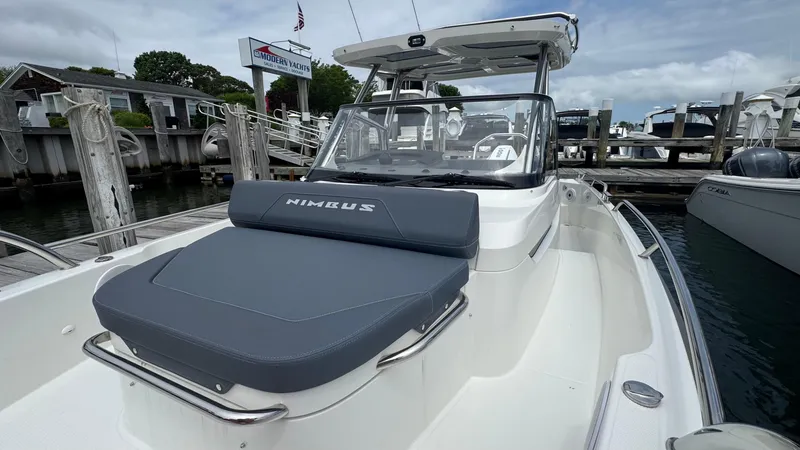 Slide: The Image of 2024 Nimbus T8 boat docked, featuring sleek design and comfortable seating. - 20