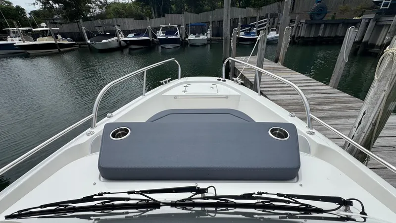 Slide: The Image of Front view of 2024 Nimbus T8 boat docked at a marina. - 24