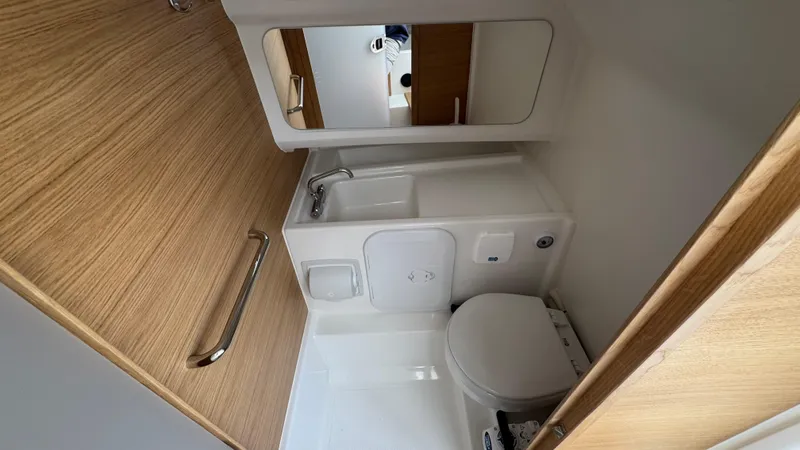 Slide: The Image of Compact bathroom in 2024 Nimbus T8 boat with wooden accents and modern fixtures. - 29