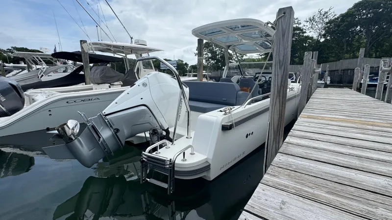 Slide: The Image of 2024 Nimbus T8 boat docked at marina, featuring sleek design and powerful outboard motor. - 4