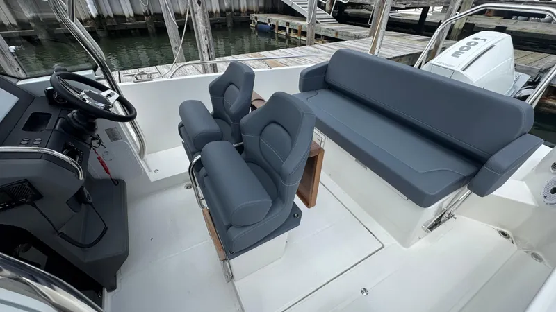 Slide: The Image of 2024 Nimbus T8 boat interior with sleek gray seating and modern helm controls. - 18