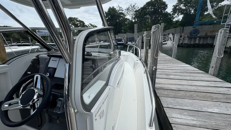 Slide: The Image of 2024 Nimbus T8 boat docked, showcasing sleek design and modern steering console. - 21