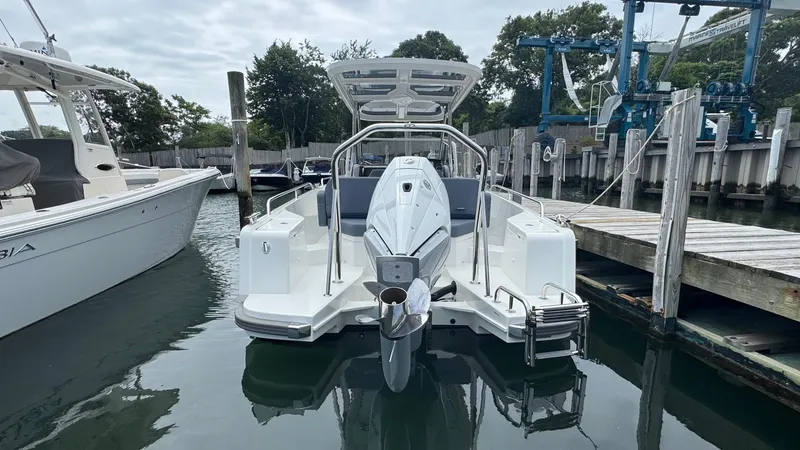 Slide: The Image of 2024 Nimbus T8 boat docked at marina, rear view with outboard motor. - 5