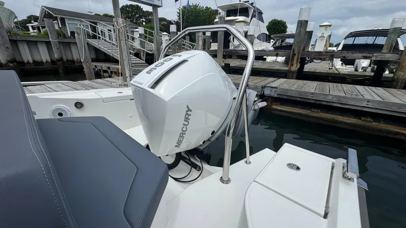 Slide: The Image of 2024 Nimbus T8 boat with Mercury outboard engine docked at marina. - 7