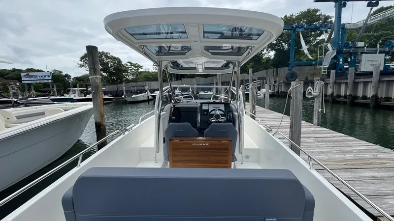 Slide: The Image of 2024 Nimbus T8 boat docked at a marina, showcasing sleek design and modern features. - 8