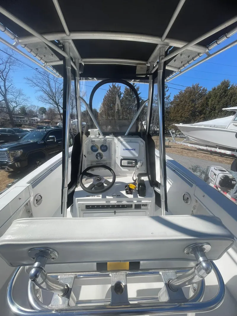 Slide: The Image of 1998 Contender 21 CC boat interior with steering console, repowered in 2018, under sunny skies. - 12