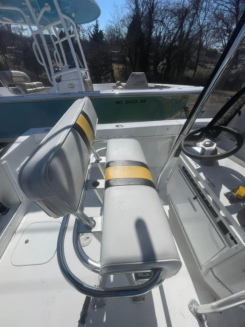 Slide: The Image of 1998 Contender 21 CC boat interior with repowered seating, steering wheel, and console. - 13