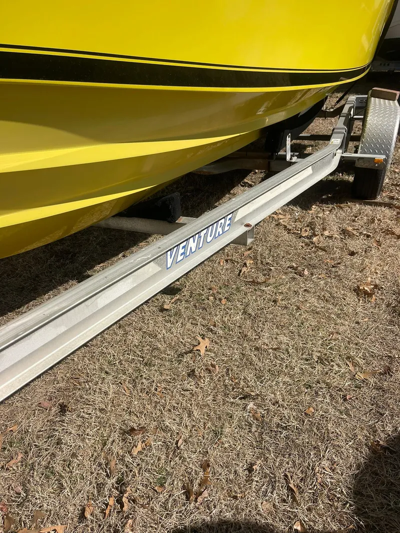 Slide: The Image of Yellow Contender 21 CC boat on Venture trailer, 1998 model, repowered in 2018. - 6
