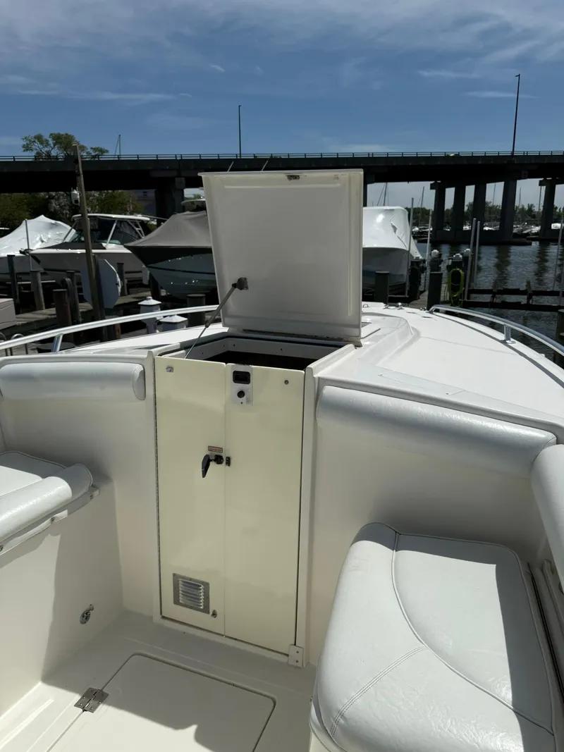 Slide: The Image of 2006 Marlago FS35 boat interior with open storage compartment, docked near a bridge. - 12